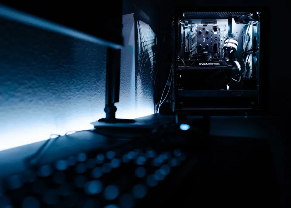 A desktop computer glowing in a dark room